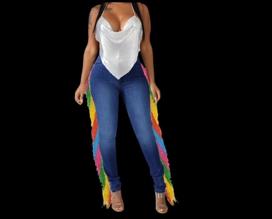 Every step is a statement. The Carnival Fringe Jean in Dark Wash pairs deep indigo denim with a full-length rainbow fringe cascade — bold, intentional, and built for the woman who owns every room she walks into.