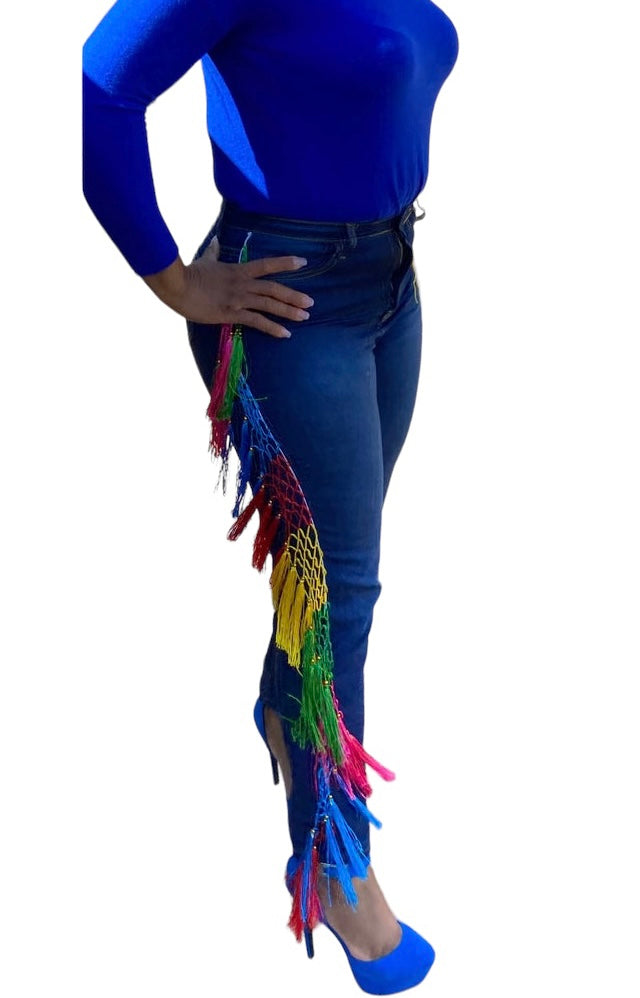 Every step is a statement. The Carnival Fringe Jean in Dark Wash pairs deep indigo denim with a full-length rainbow fringe cascade — bold, intentional, and built for the woman who owns every room she walks into.