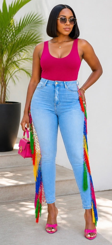 Light denim. Heavy presence. The Carnival Fringe Jean in Light Wash brings sun-washed ease to a full-length rainbow fringe cascade — effortless on the surface, impossible to ignore in person.