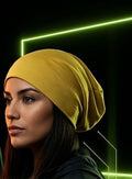 The Satin Crown Beanie in Goldenrod doesn’t blend in — and that’s the point. A rich mustard yellow exterior in a 90% cotton and 10% spandex blend wraps around a smooth satin lining that keeps your edges intact and your style sharp.