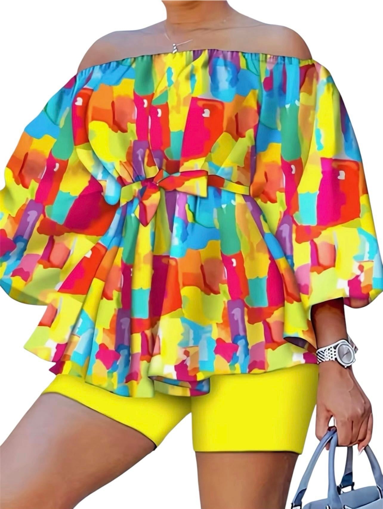 The Palette Two-Piece Set is for the woman who lives in full color. A vibrant abstract paint-block print in yellow, orange, teal, pink, and purple cascades across an off-shoulder peplum top with voluminous balloon sleeves — cinched at the waist with a matching belt tie and anchored by bold yellow biker shorts that pull the whole canvas together.