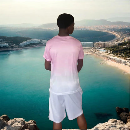 A soft pink gradient fades to white across an oversized crewneck tee anchored by a bold crowned gorilla graphic — street art energy meets resort ease. Paired with clean white shorts that let the top lead without competition.