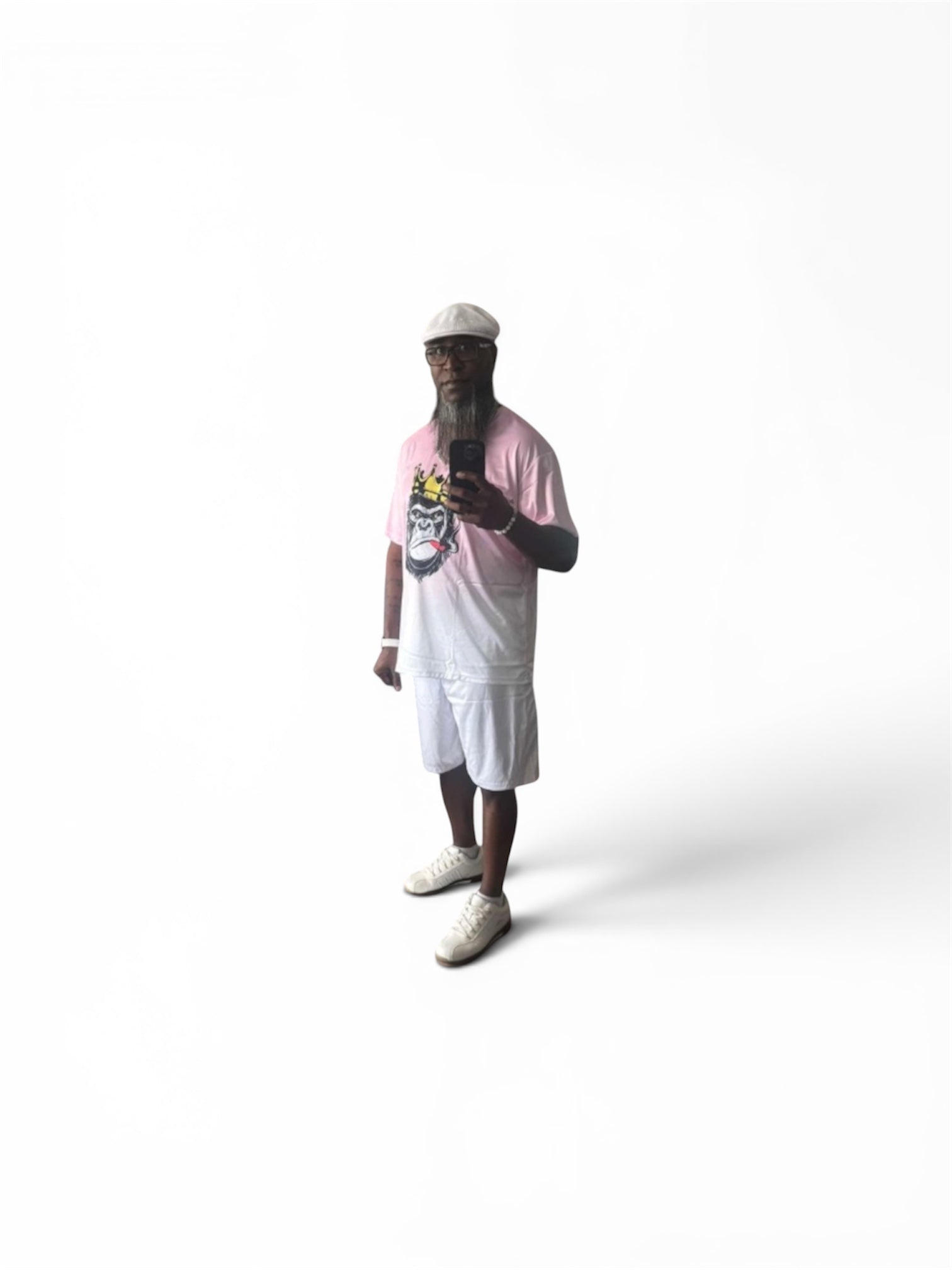 A soft pink gradient fades to white across an oversized crewneck tee anchored by a bold crowned gorilla graphic — street art energy meets resort ease. Paired with clean white shorts that let the top lead without competition.
