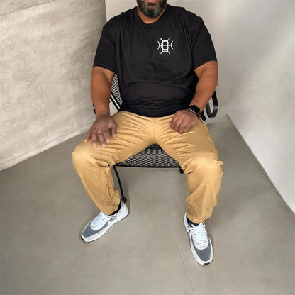 Black is the baseline of every serious wardrobe — and The Mark Crew elevates it. A 100% cotton crewneck in deep black carries the TAUGEMPIE crest mark on the left chest and the full signature logo graphic across the back. Front and back, the brand speaks.