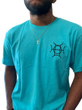 The Mark Crew in Blue doesn’t blend into the background — it owns it. A striking turquoise 100% cotton crewneck carries the TAUGEMPIE crest mark on the left chest and the full signature logo graphic across the back in vivid blue, green, and gold.
