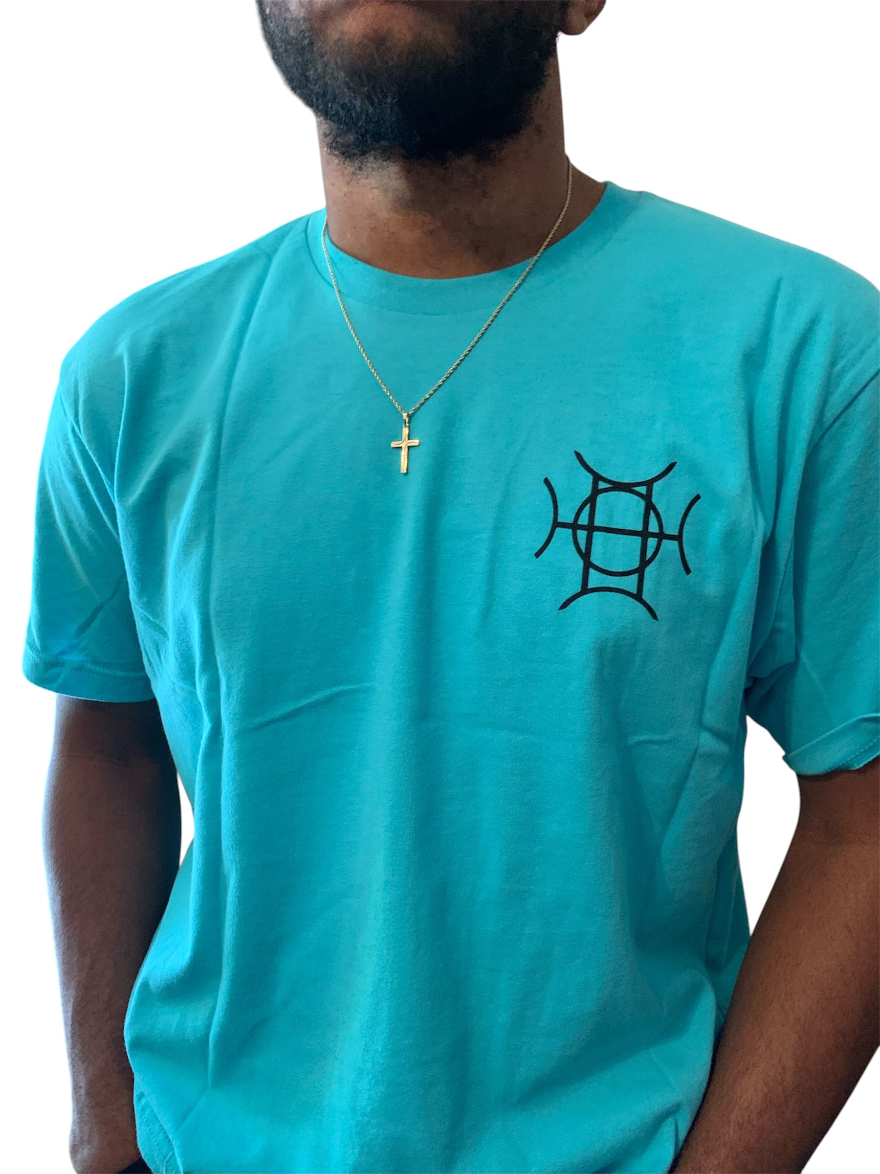 The Mark Crew in Blue doesn’t blend into the background — it owns it. A striking turquoise 100% cotton crewneck carries the TAUGEMPIE crest mark on the left chest and the full signature logo graphic across the back in vivid blue, green, and gold.
