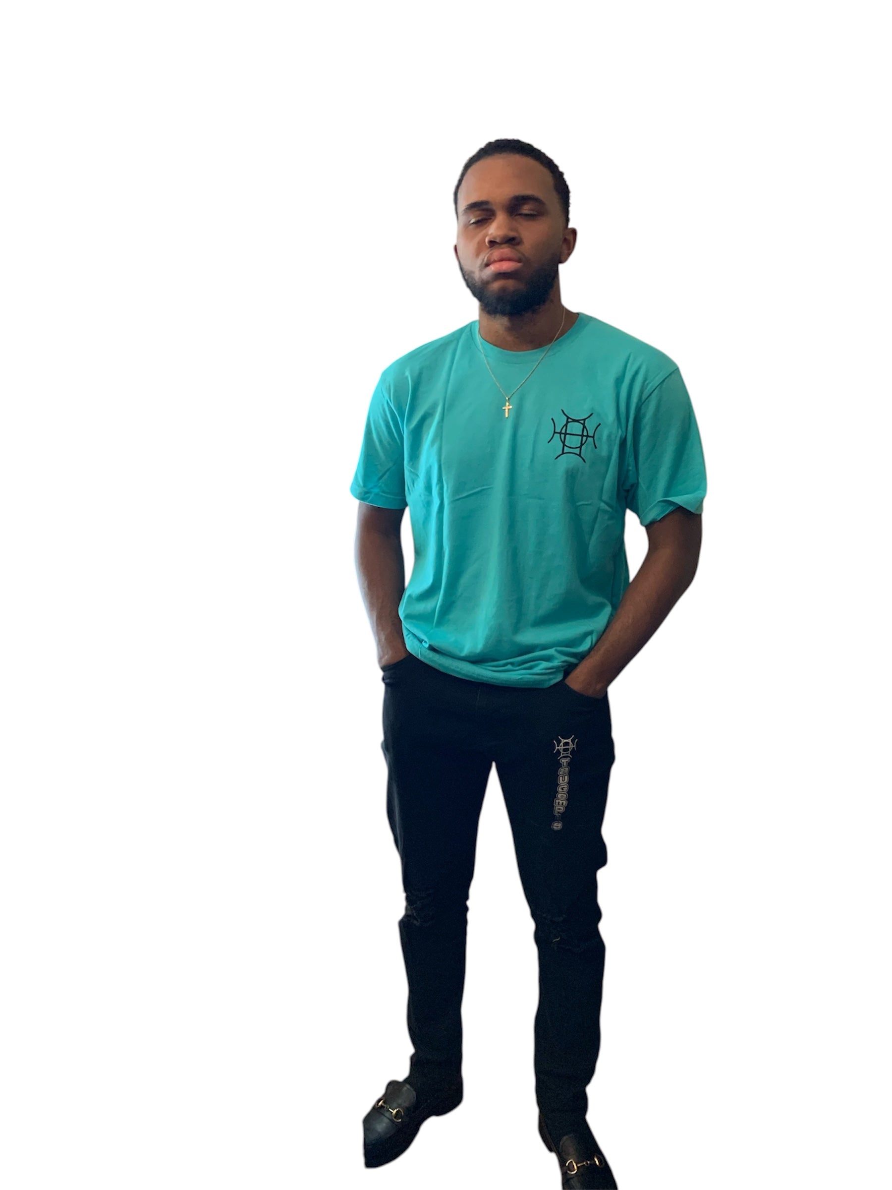 The Mark Crew in Blue doesn’t blend into the background — it owns it. A striking turquoise 100% cotton crewneck carries the TAUGEMPIE crest mark on the left chest and the full signature logo graphic across the back in vivid blue, green, and gold.
