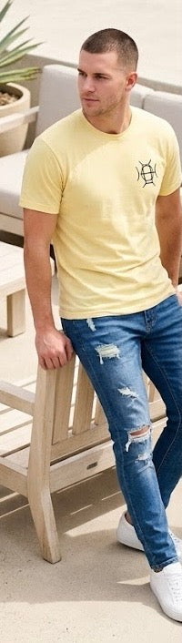 Light tone. Heavy presence. The Mark Crew in Yellow is the warm-weather essential — soft yellow cotton, TAUGEMPIE crest on the chest, full signature logo on the back, and energy that speaks for itself.