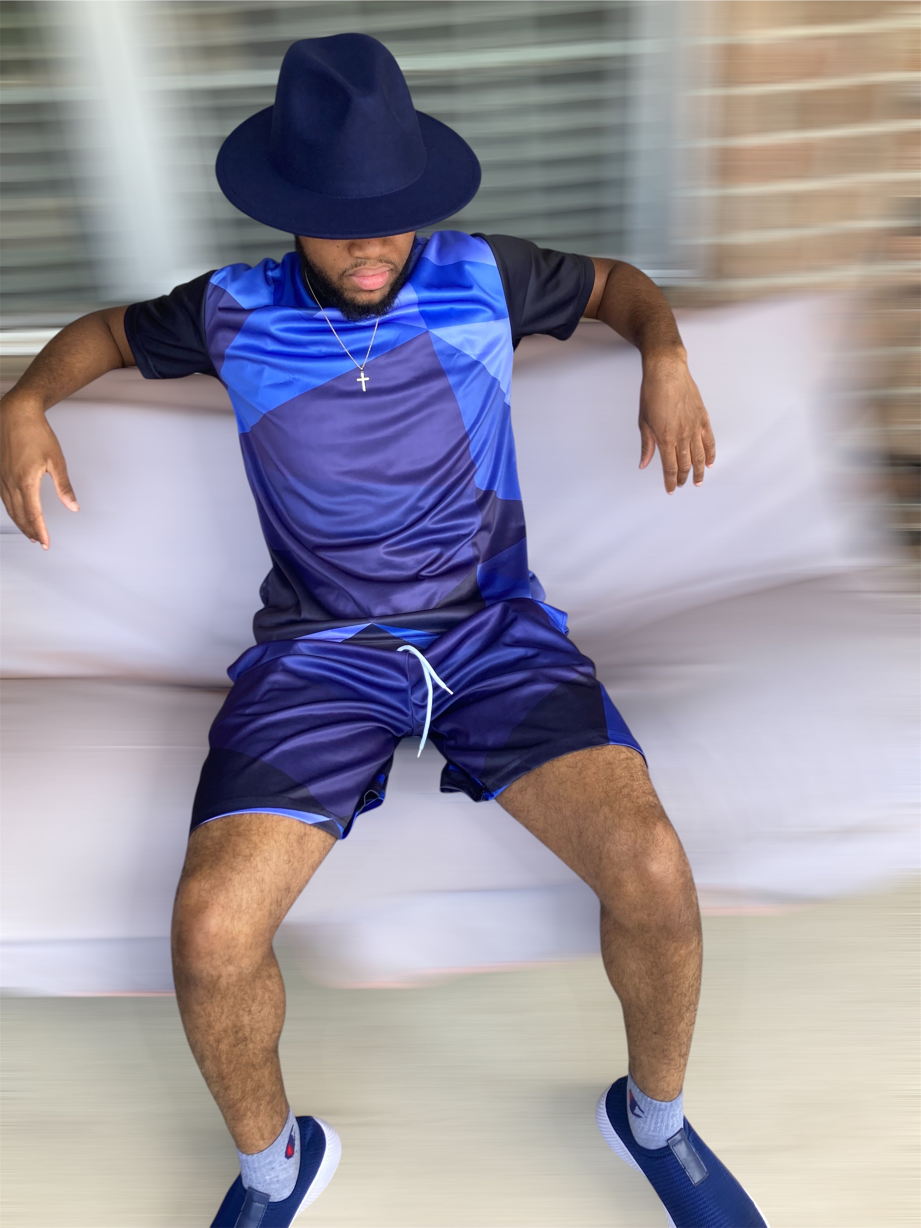 The Prism Set is built for the man who moves with purpose. A bold geometric diamond print in deep navy and black covers a fitted crewneck tee — structured, angular, and unmistakably intentional. Paired with clean navy shorts that ground the look with simplicity.